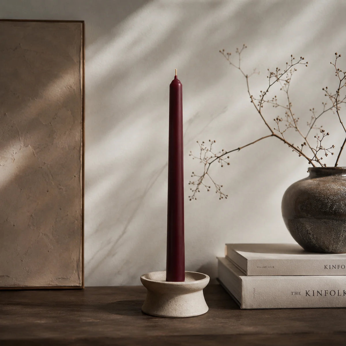 Burgundy taper candle in candle holder, home decor styling